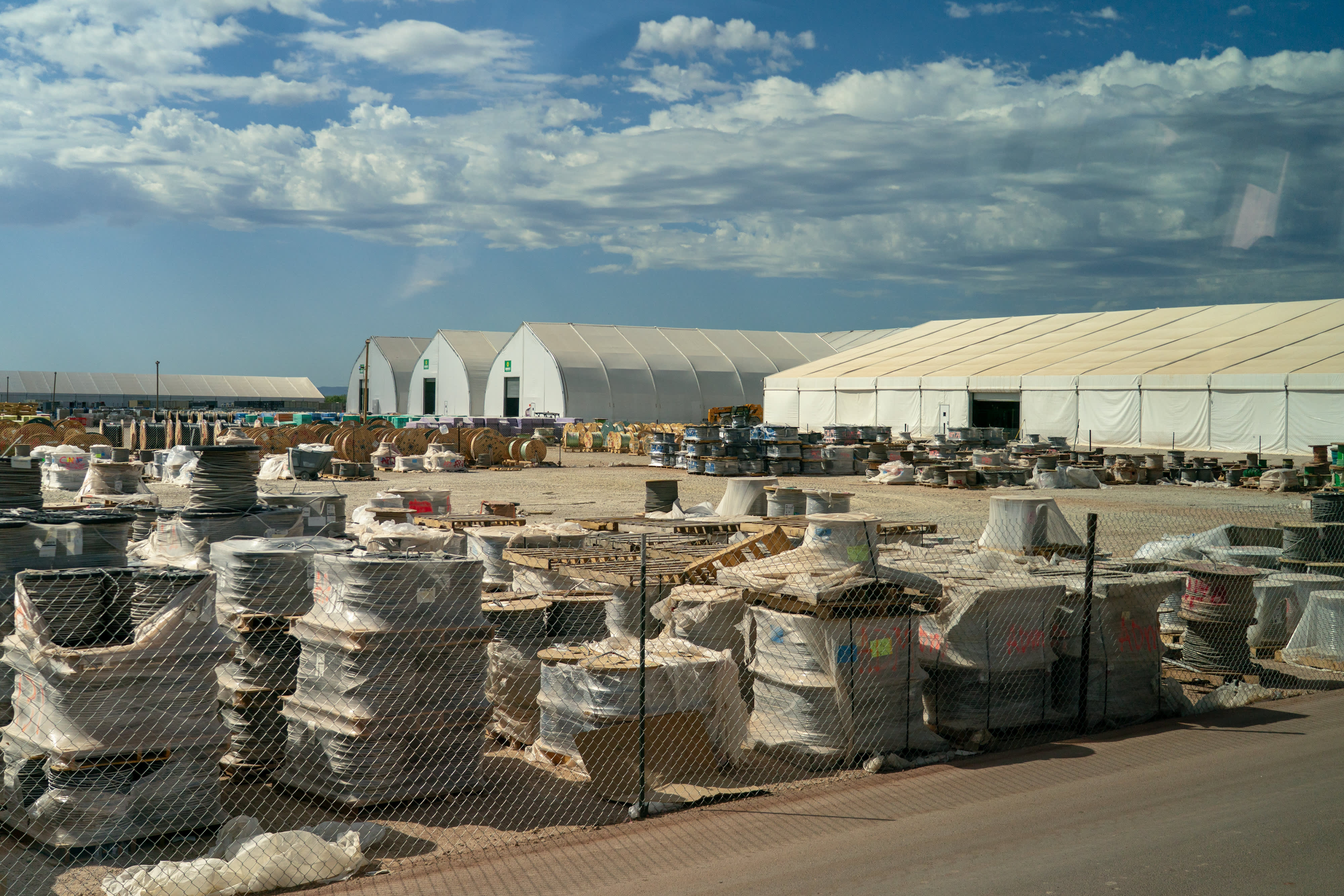 Spools of electrical wires outside a series of assembly tents during a media tour of the Stargate AI data center in Abilene, Texas, US, on Tuesday, Sept. 23, 2025. Stargate is a collaboration of OpenAI, Oracle and SoftBank, with promotional support from President Donald Trump, to build data centers and other infrastructure for artificial intelligence throughout the US.